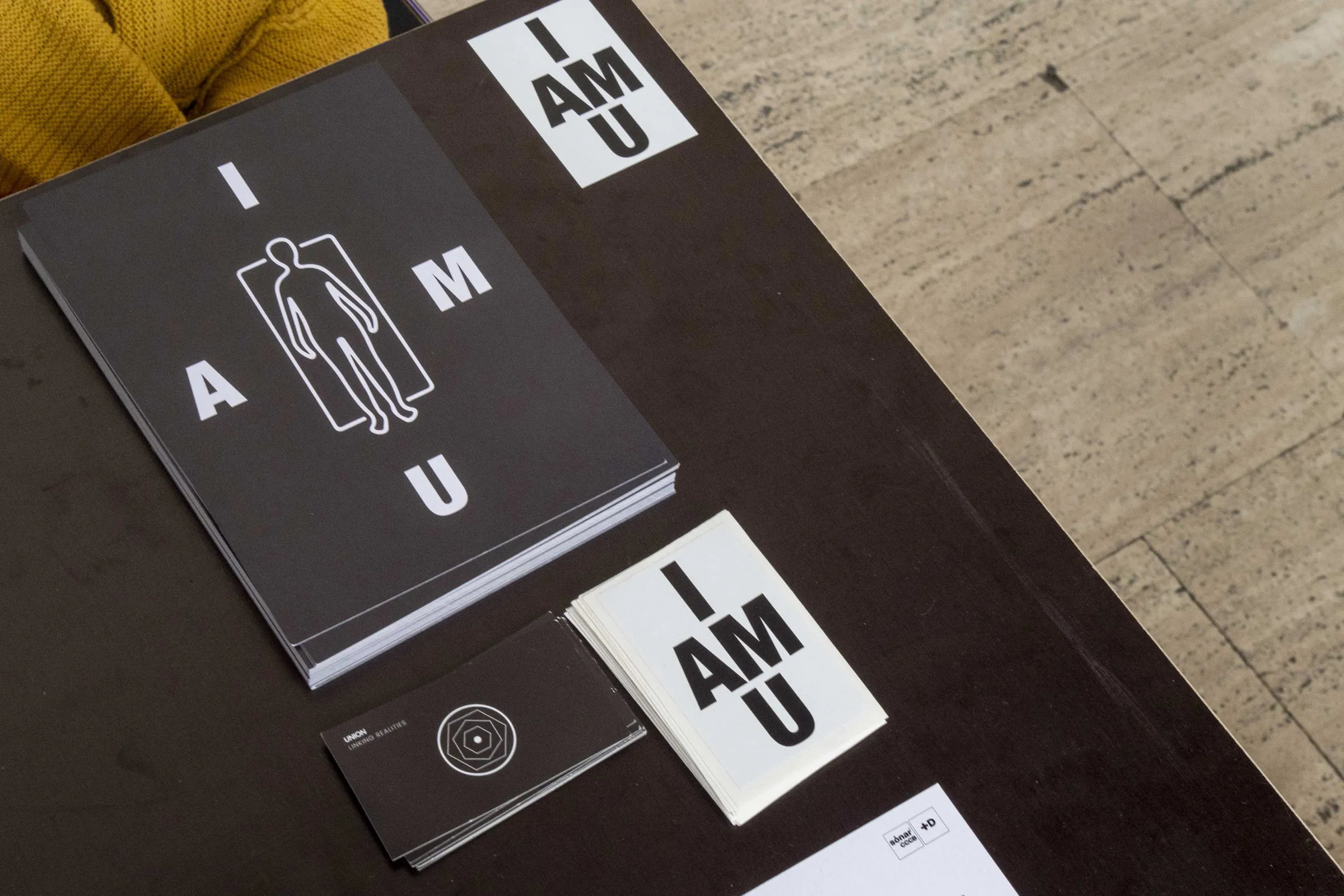 Table shot of stacked I AM YOU print materials