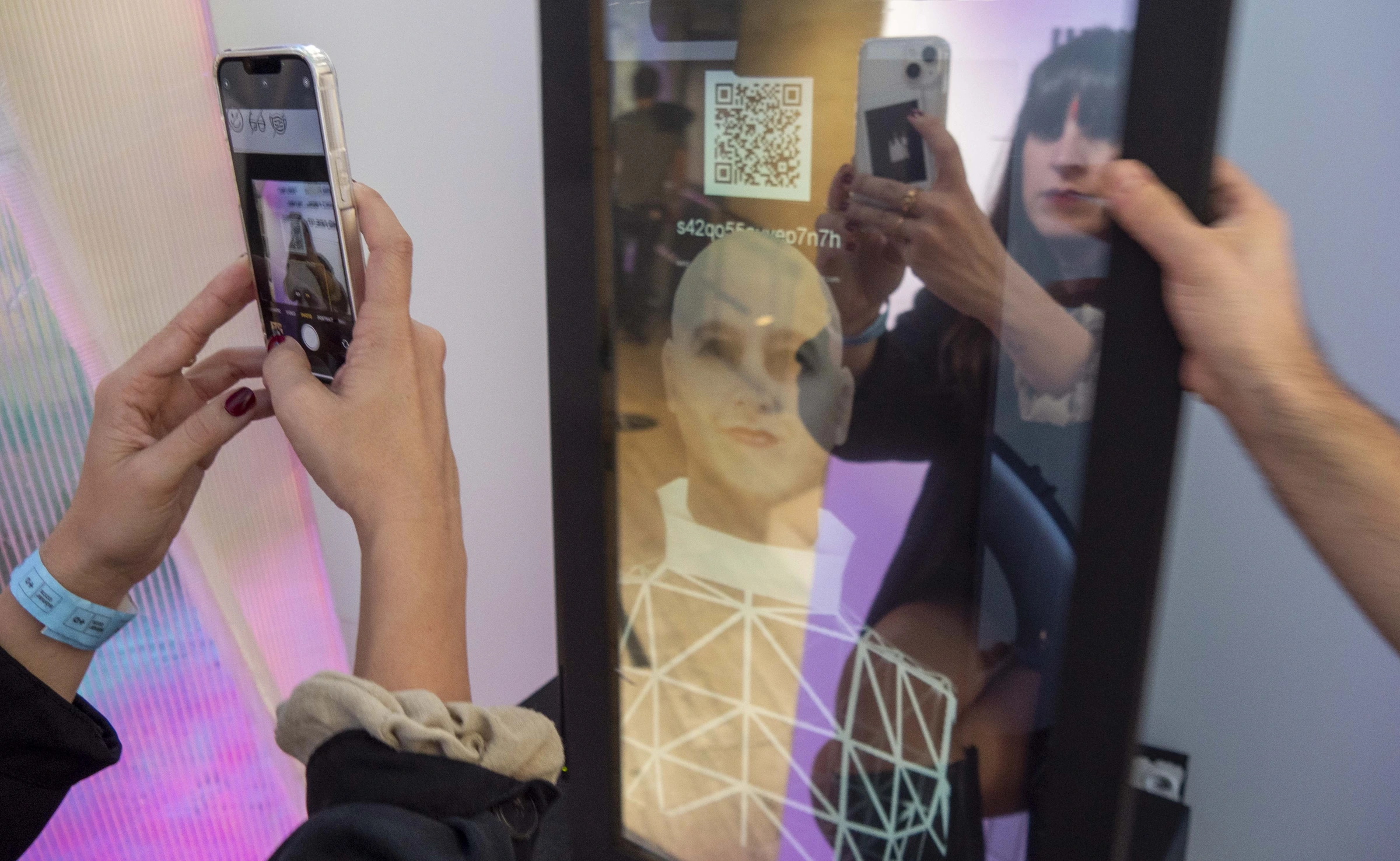 Visitors scanning the QR code on the mirror screen to retrieve their AR avatar